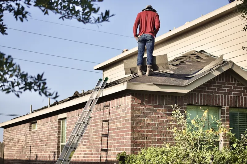 Professional roofer working on a residential roof in Downtown Englewood